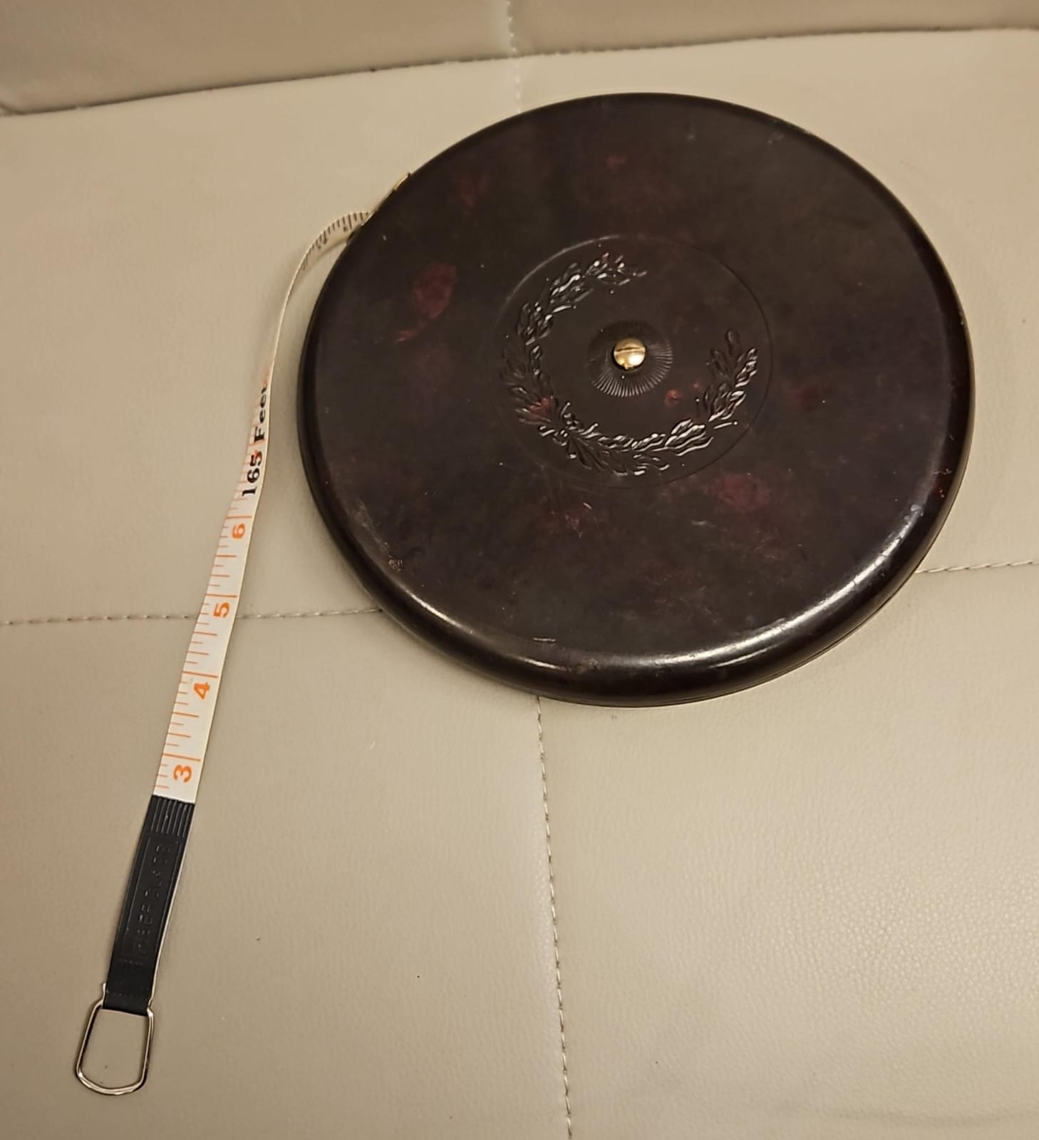 The main photo for Vintage Measuring tape 165 it or 50 metres with Bakelite case with Tortoiseshell pattern with a brass central winding mechanism